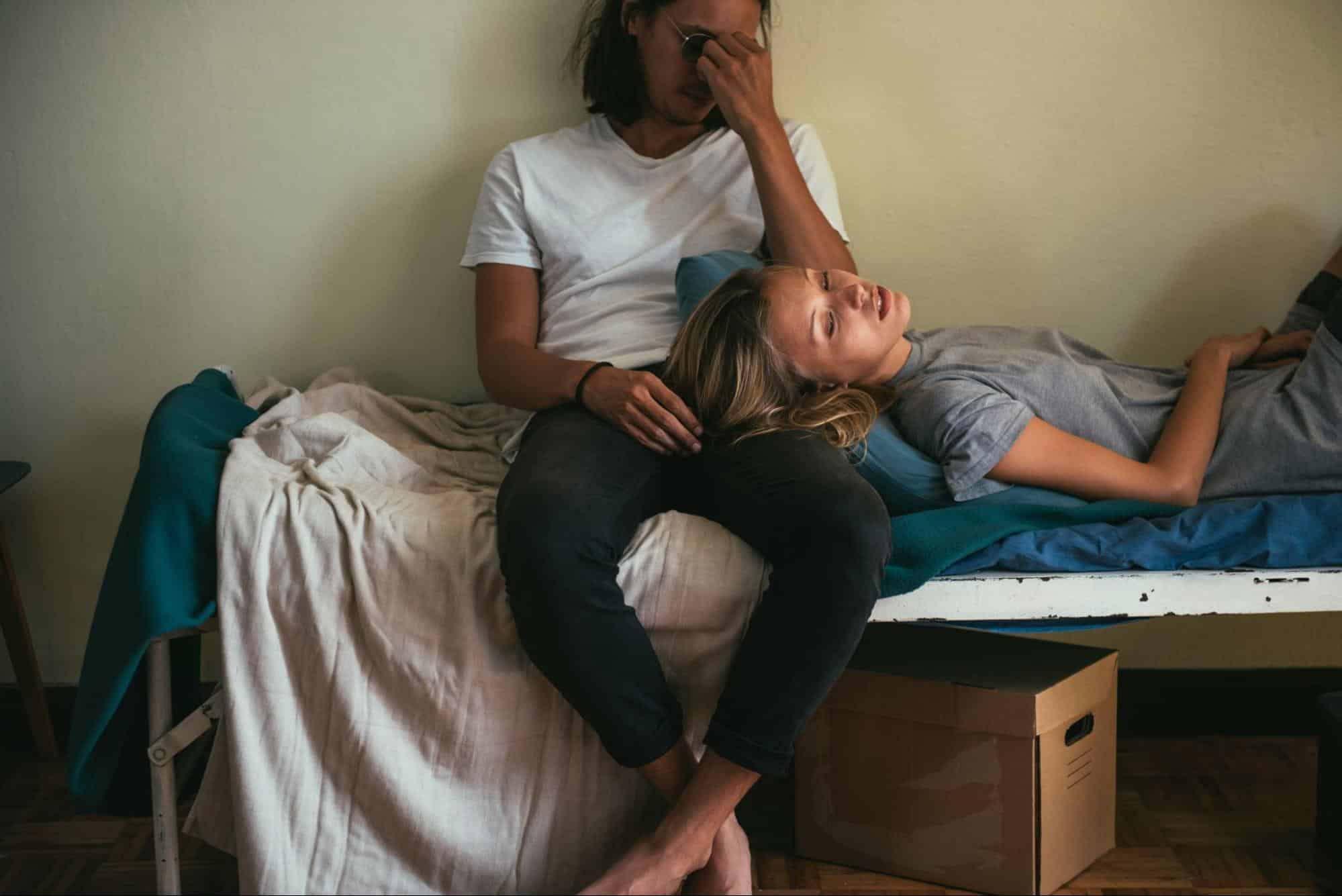A woman resting on a man’s lap