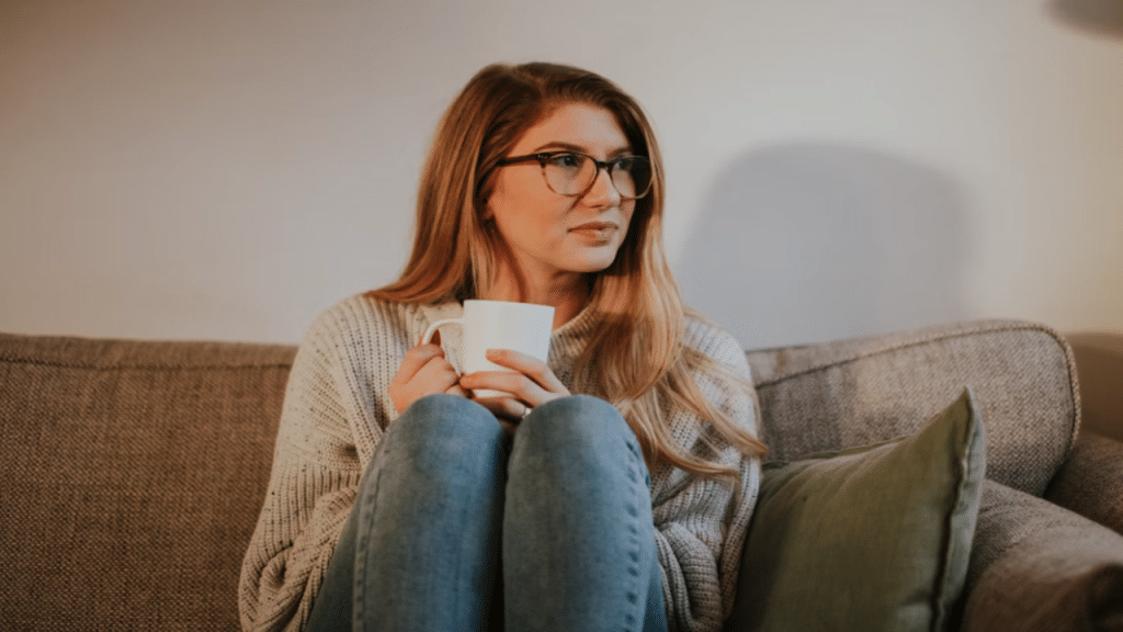 A woman thinking while having coffee