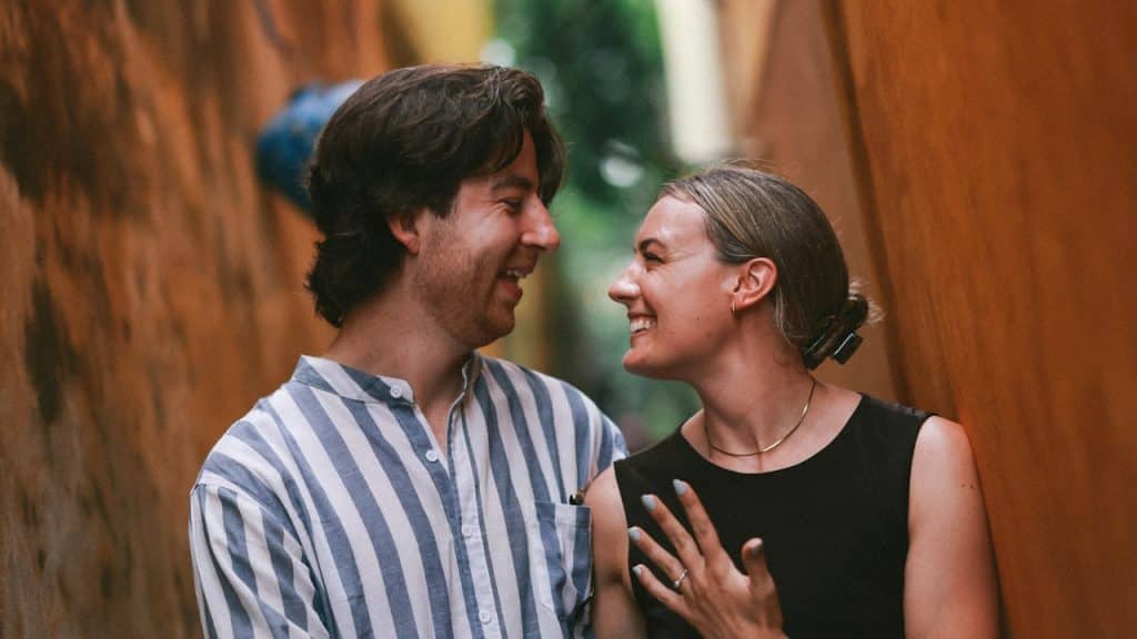 A couple smiling at each other.