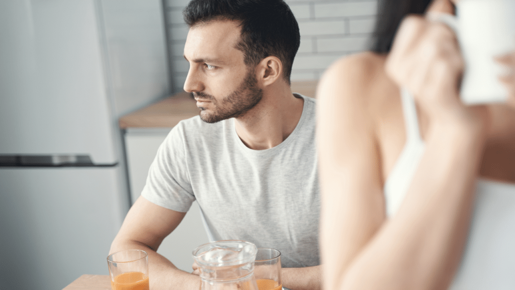 A man looking ambivalent during breakfast