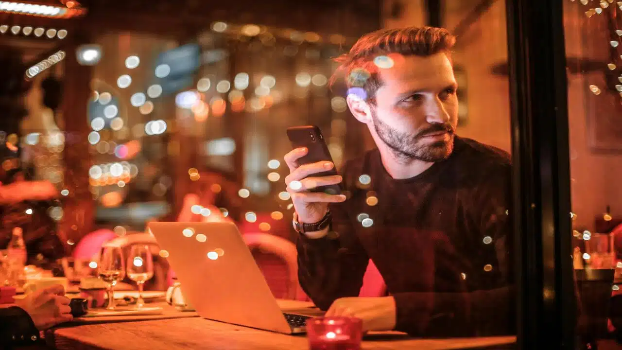 A man using his phone at a restaurant