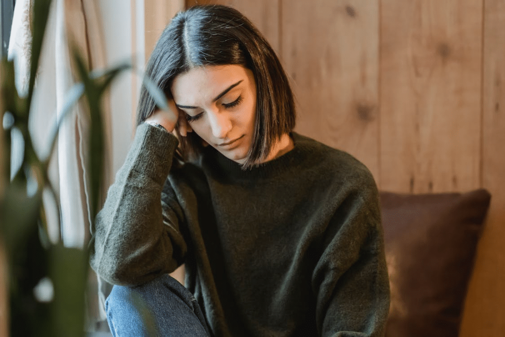 Sleepy woman having rest near window
