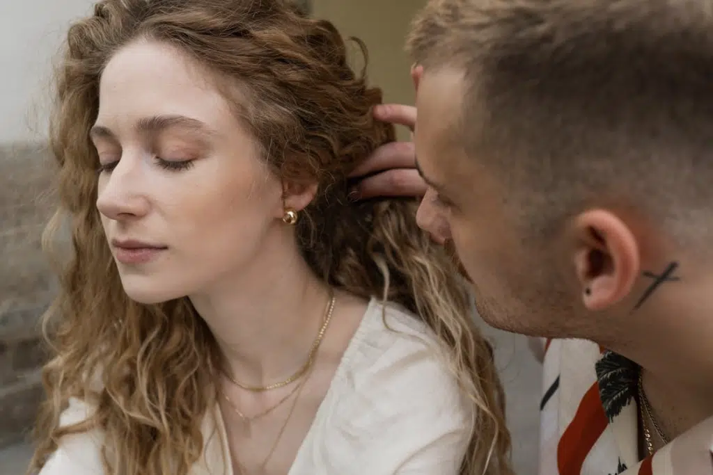 A man touching a woman’s hair