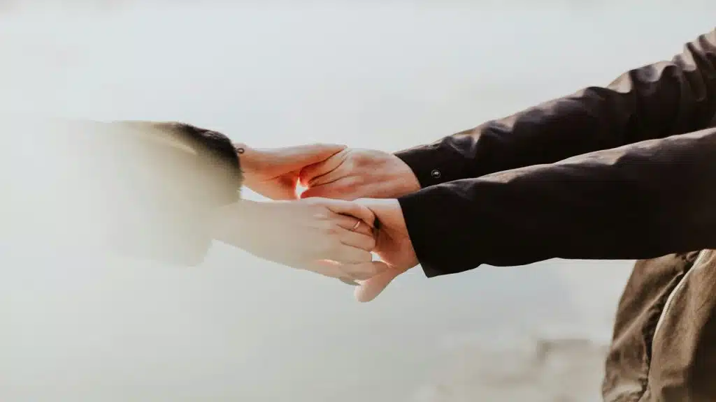 A couple holding each other’s hands