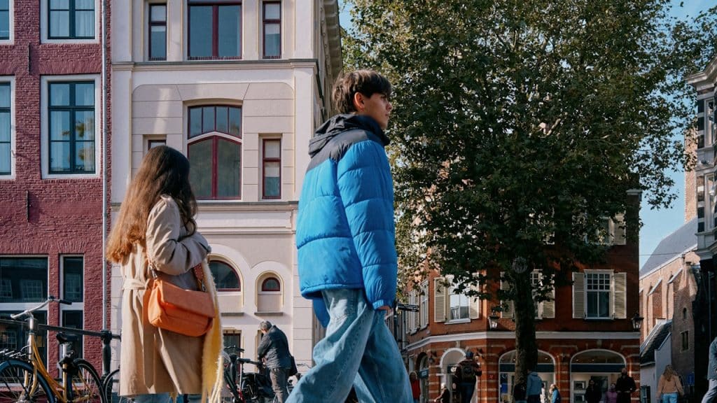 A man and a woman walking down a street.