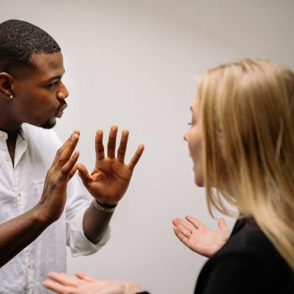 A man and a woman arguing intensely.