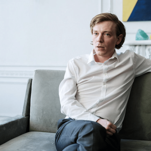A man sitting on a green couch