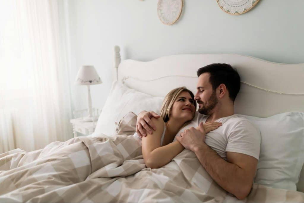 A man and woman at the bed
