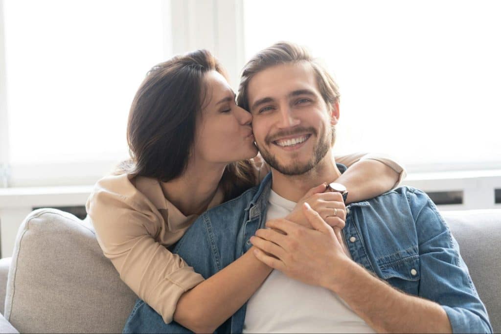 A woman kissing a man’s cheek