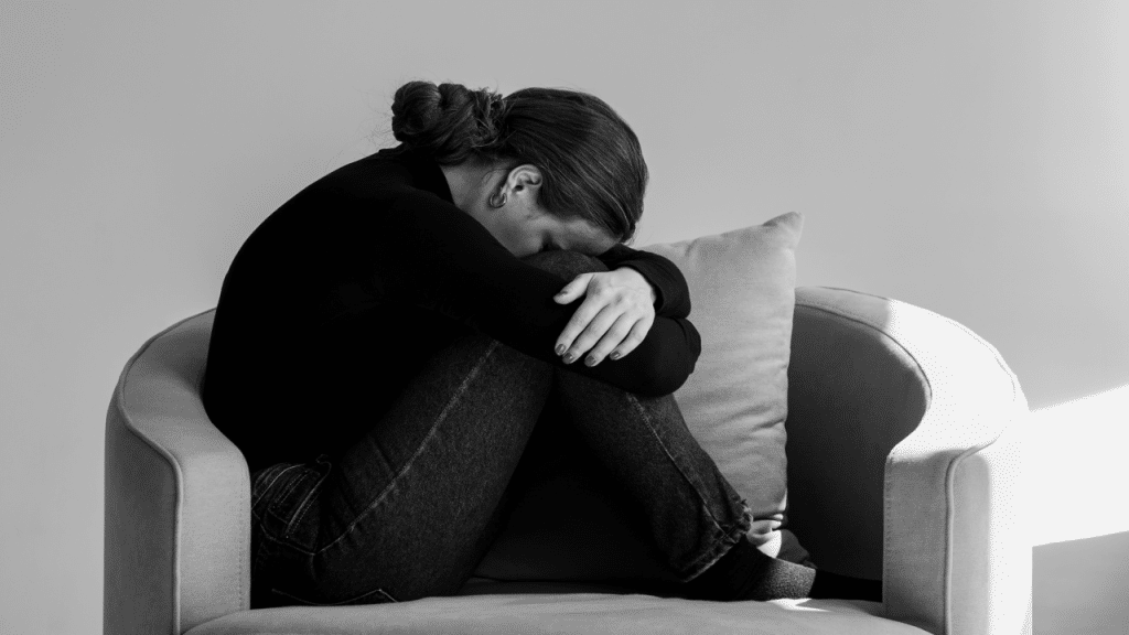 A woman looking sad at home