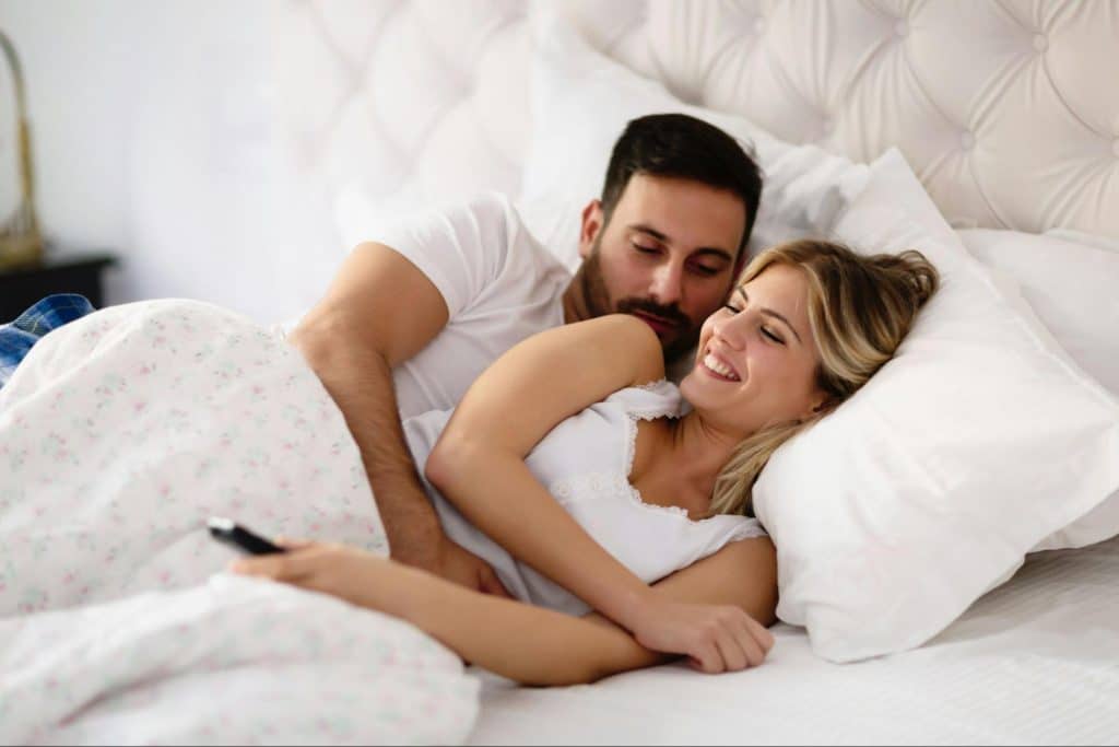A man and woman at the bed