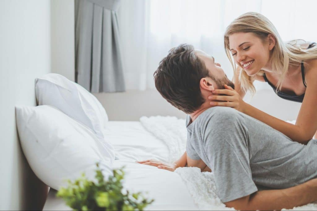 A man and woman at the bed