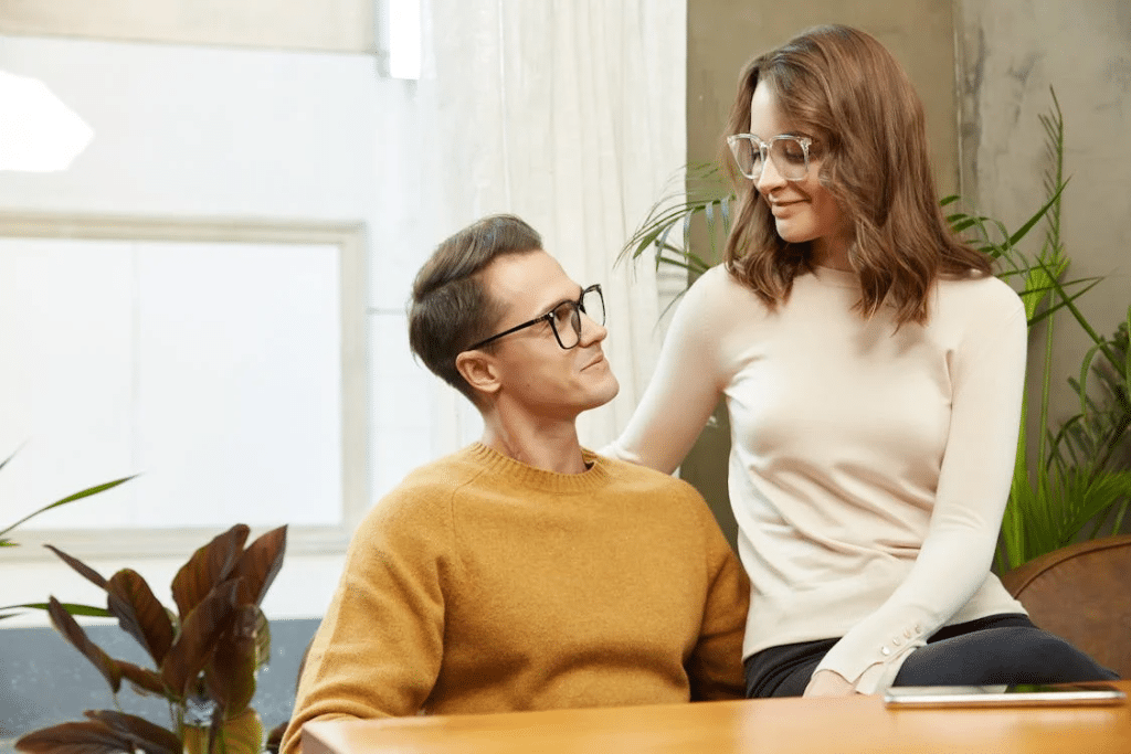 Stylish Couple Indoors Wearing Glasses