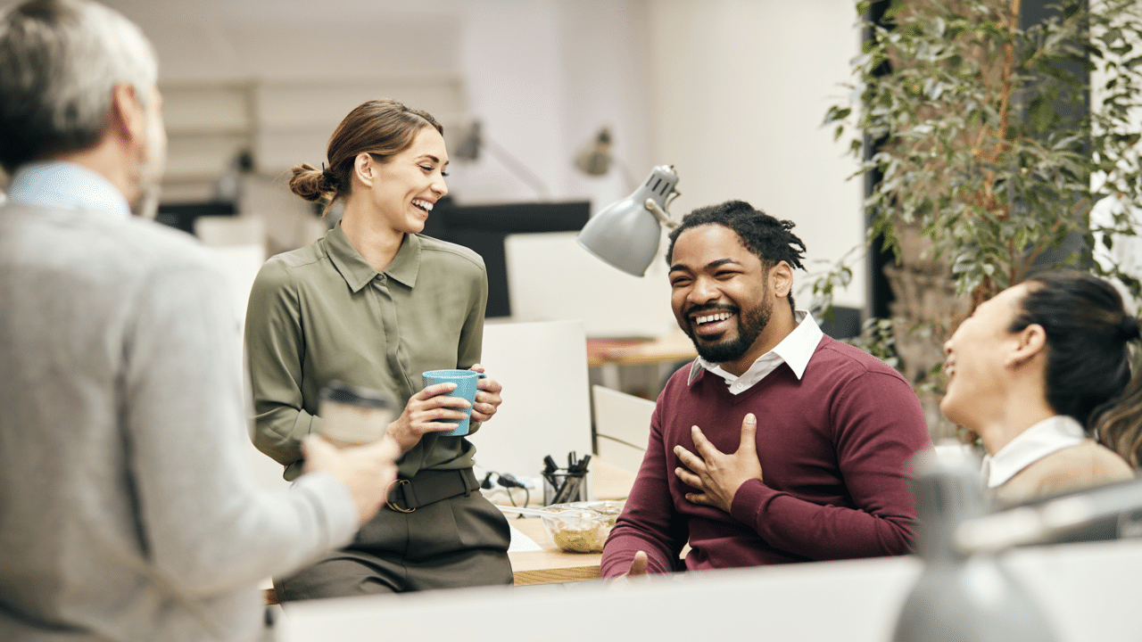 Colleagues laughing together at work 