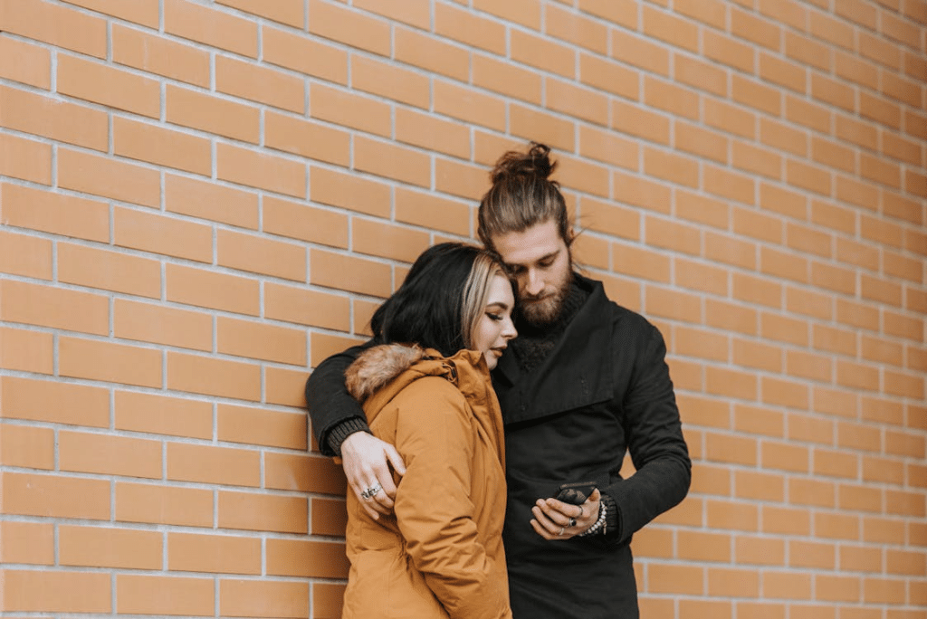 A man and a woman looking at the phone