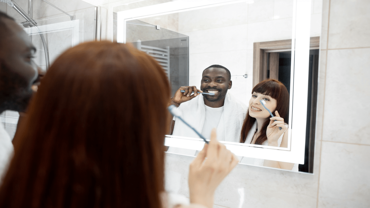 A couple brushing their teeth together