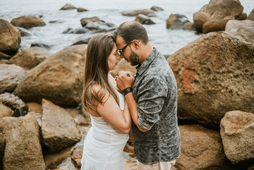 A couple standing by the sea