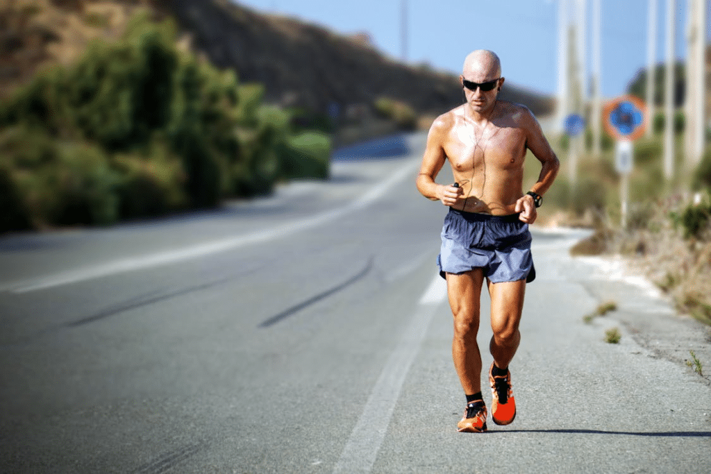 A man running at the side of the street