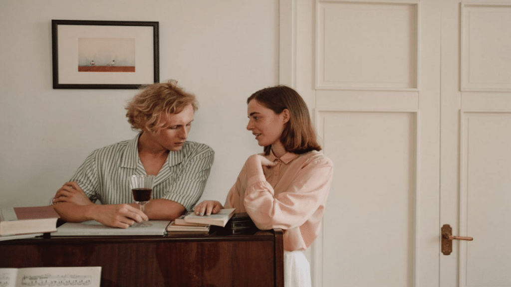A couple talking by the piano 
