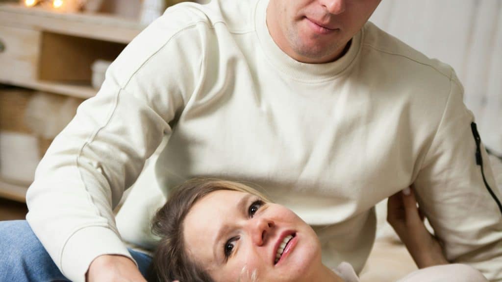 A woman sitting on the lap of a man.