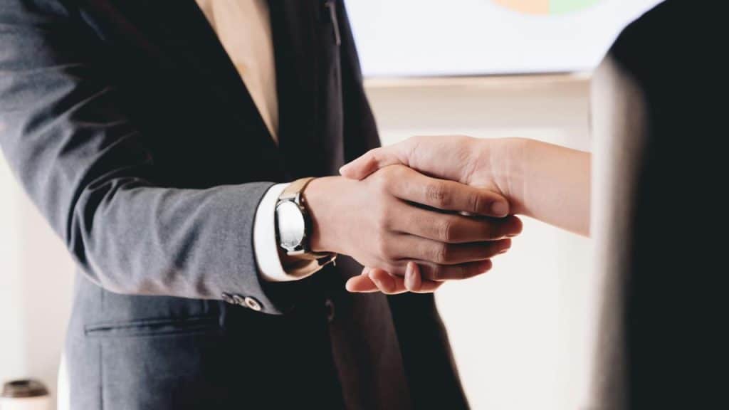 A close-up of two people shaking hands.