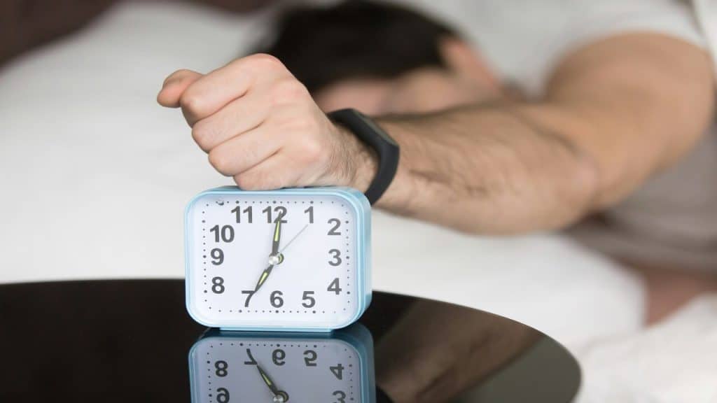 A man waking up at 7am