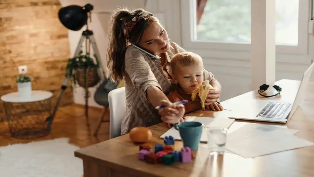 A mom working while taking care of her baby