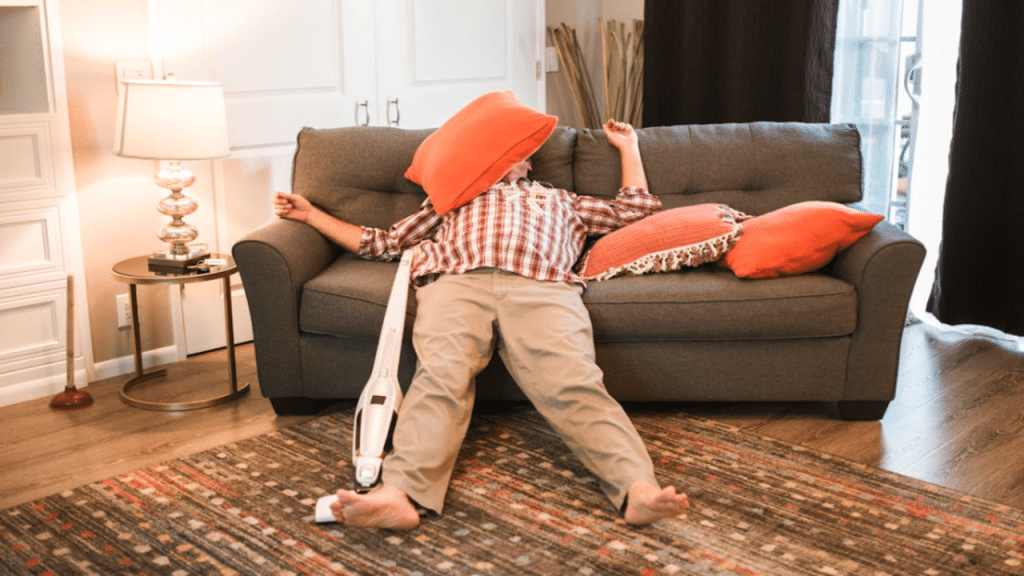 A man procrastinating on cleaning