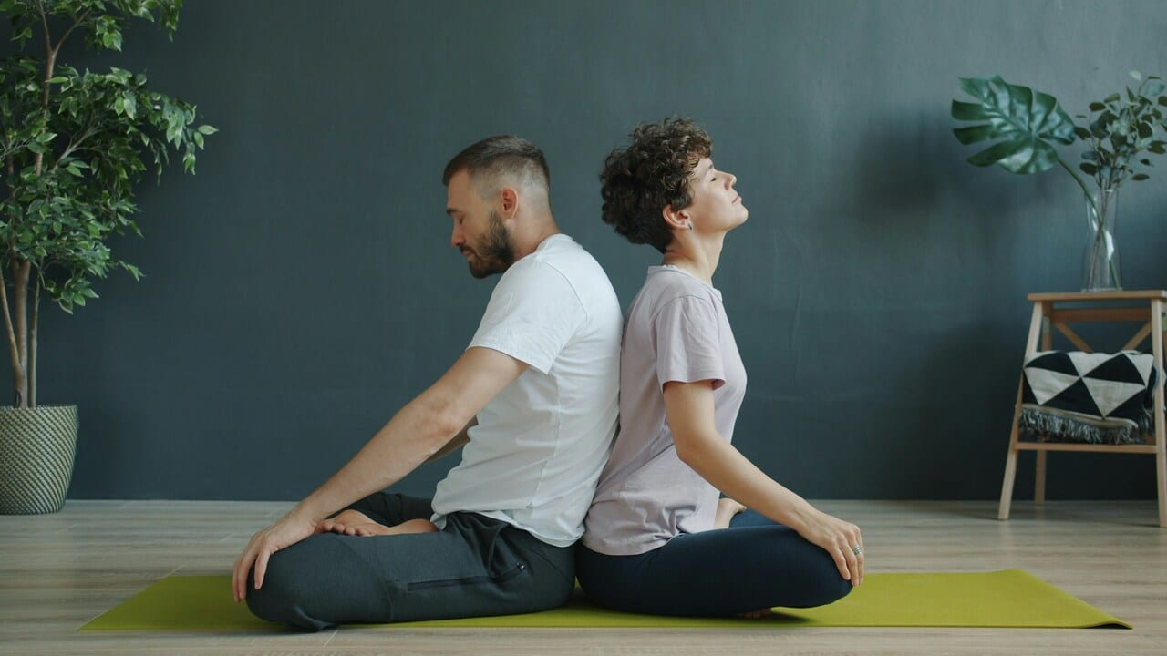 A couple doing yoga together 