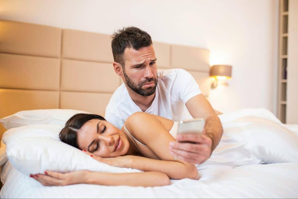 A man checking on woman’s phone