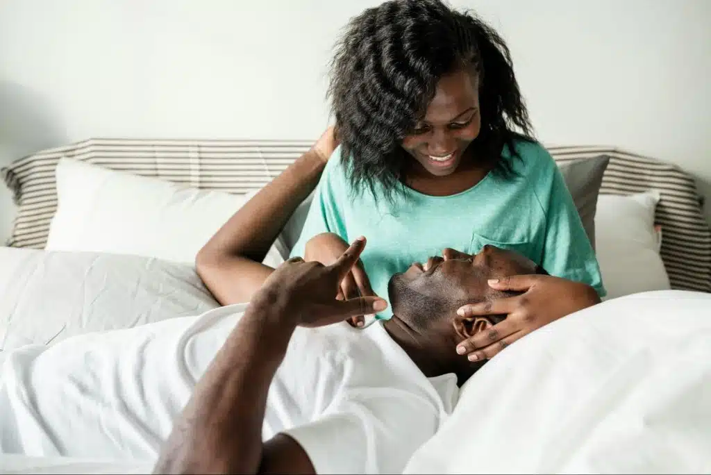 A man laying on a woman’s lap