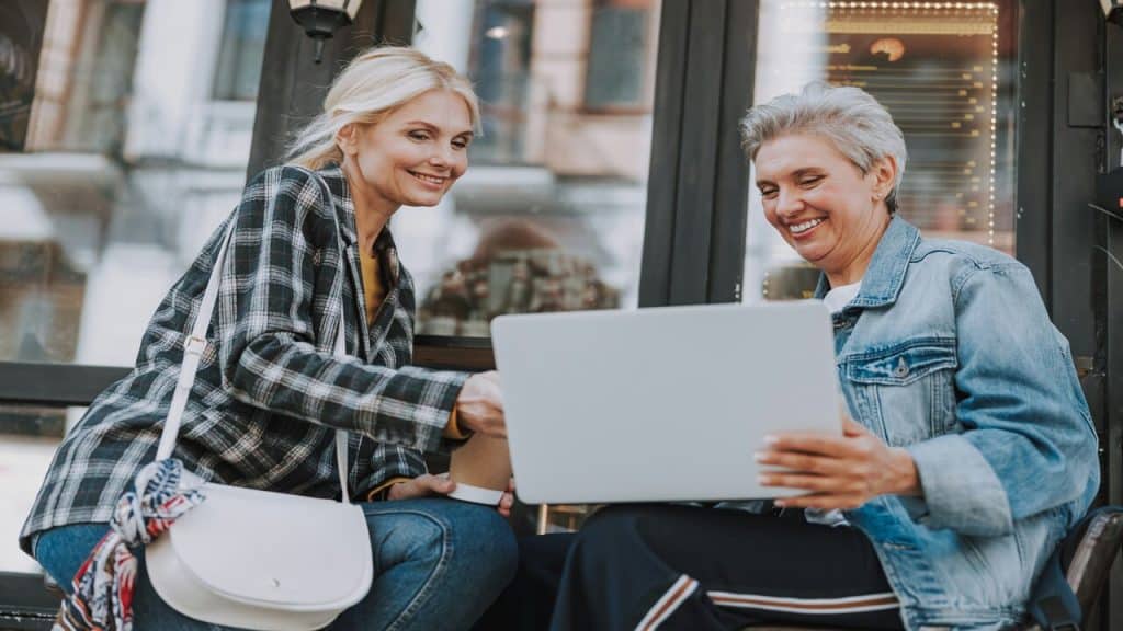 Female friends looking at a laptop 