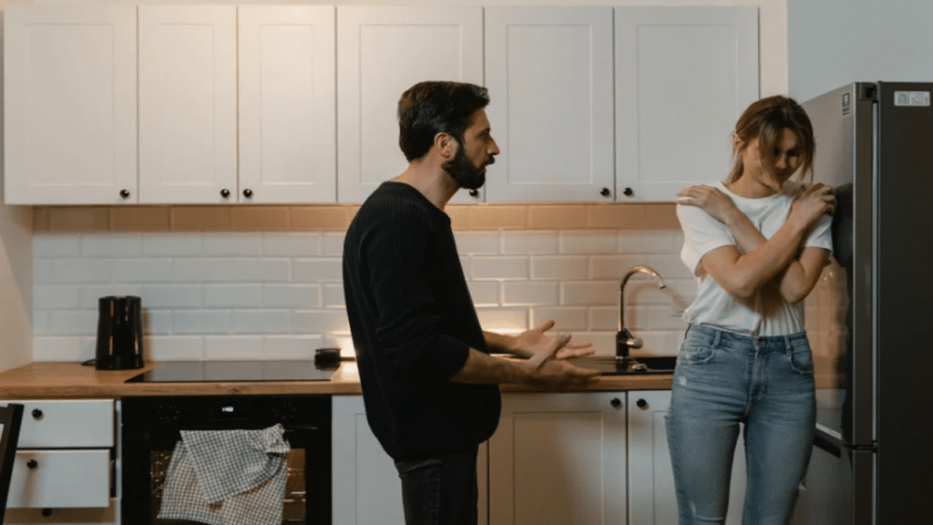 A man yelling at his wife in the kitchen 