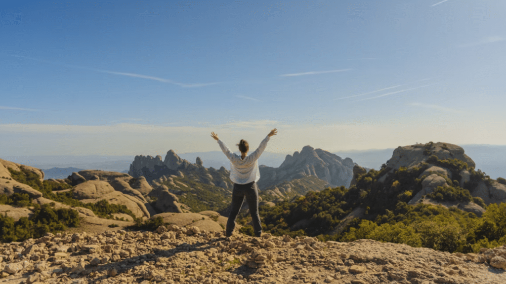 A woman on top of a mountain