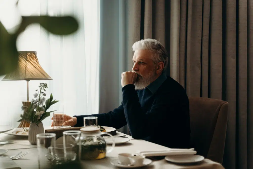 An old man sitting at the table