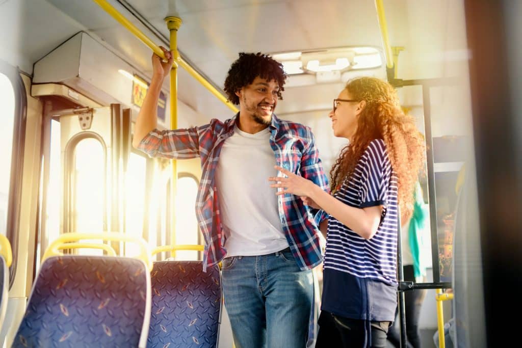 The couple is standing in a bus.
