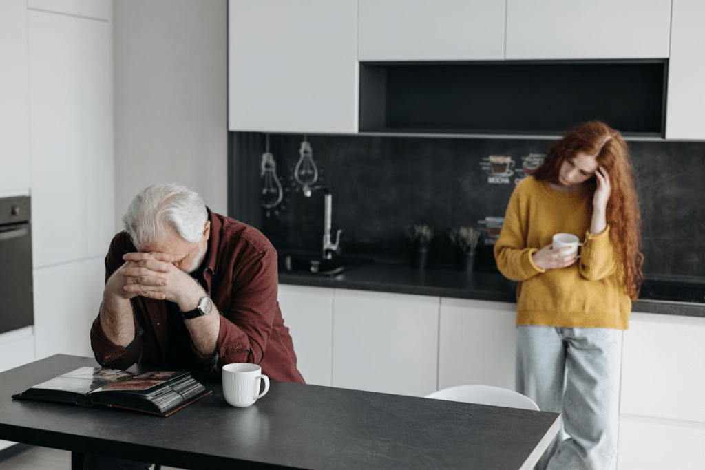 A man and woman looking sad in the kitchen