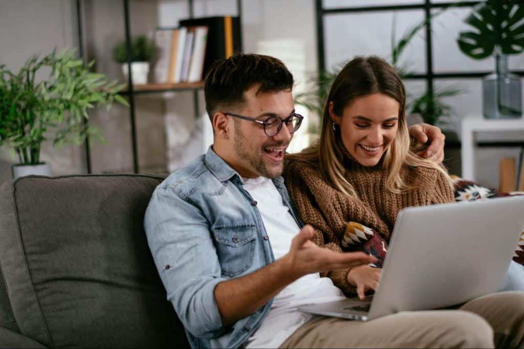 A man and woman looking at the laptop