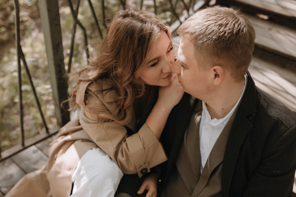 A couple sitting on a wooden bridge