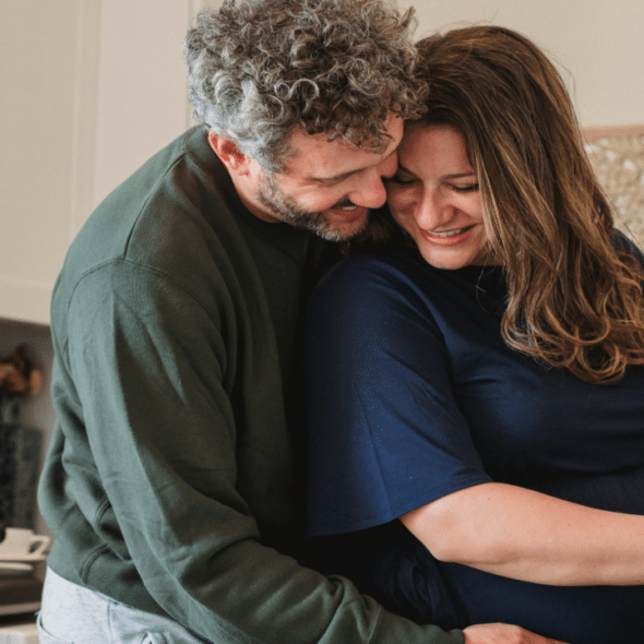 A couple hugging in the kitchen