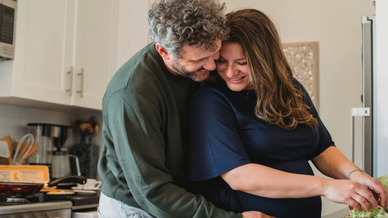 A couple hugging in the kitchen