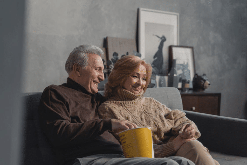 An elderly couple relaxing on a couch