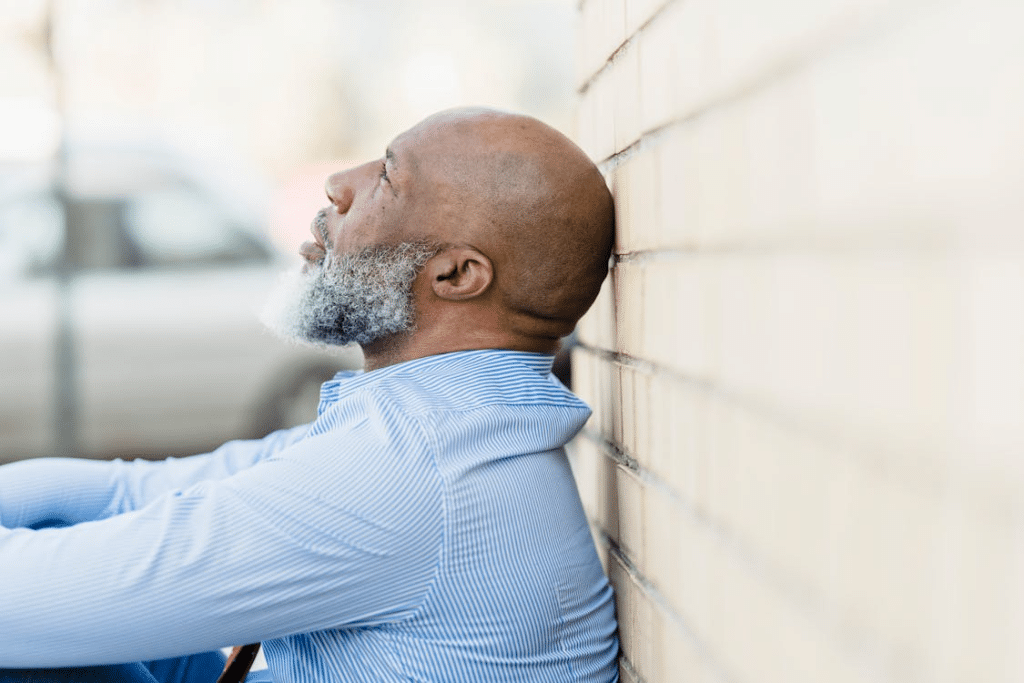A troubled man sitting on the ground