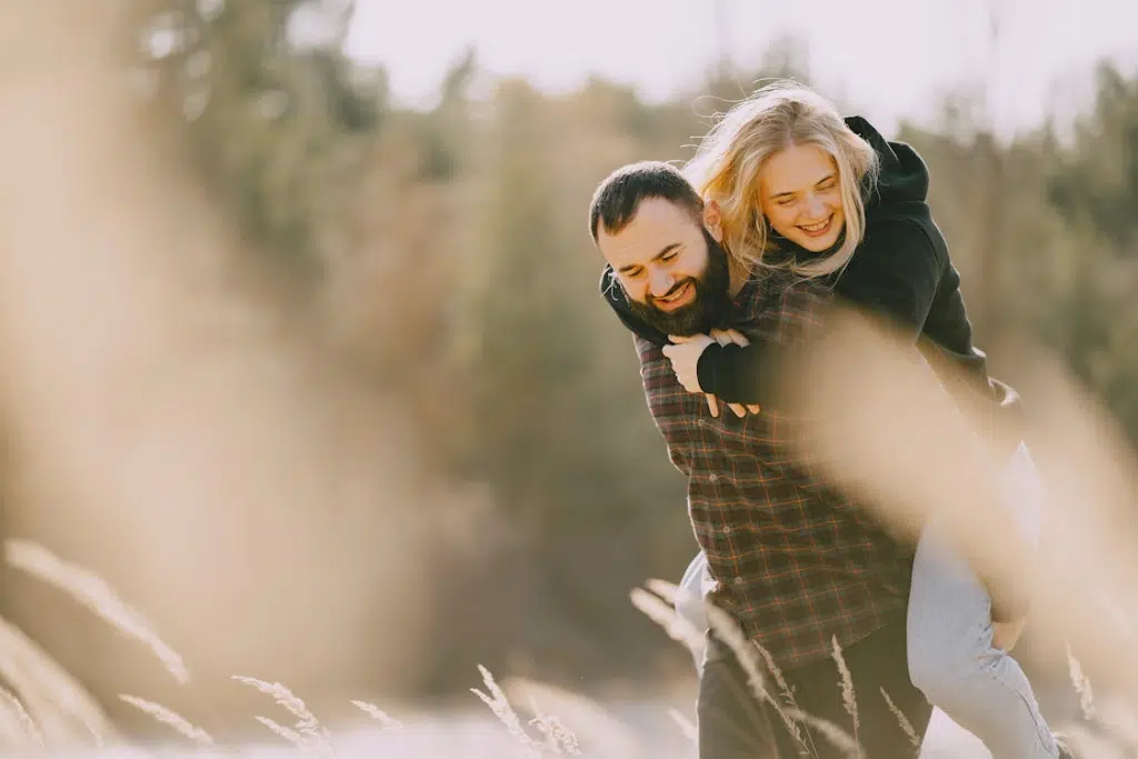 A man carrying a woman on his back