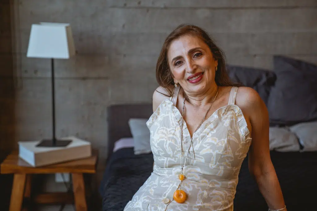 A woman in a dress smiling