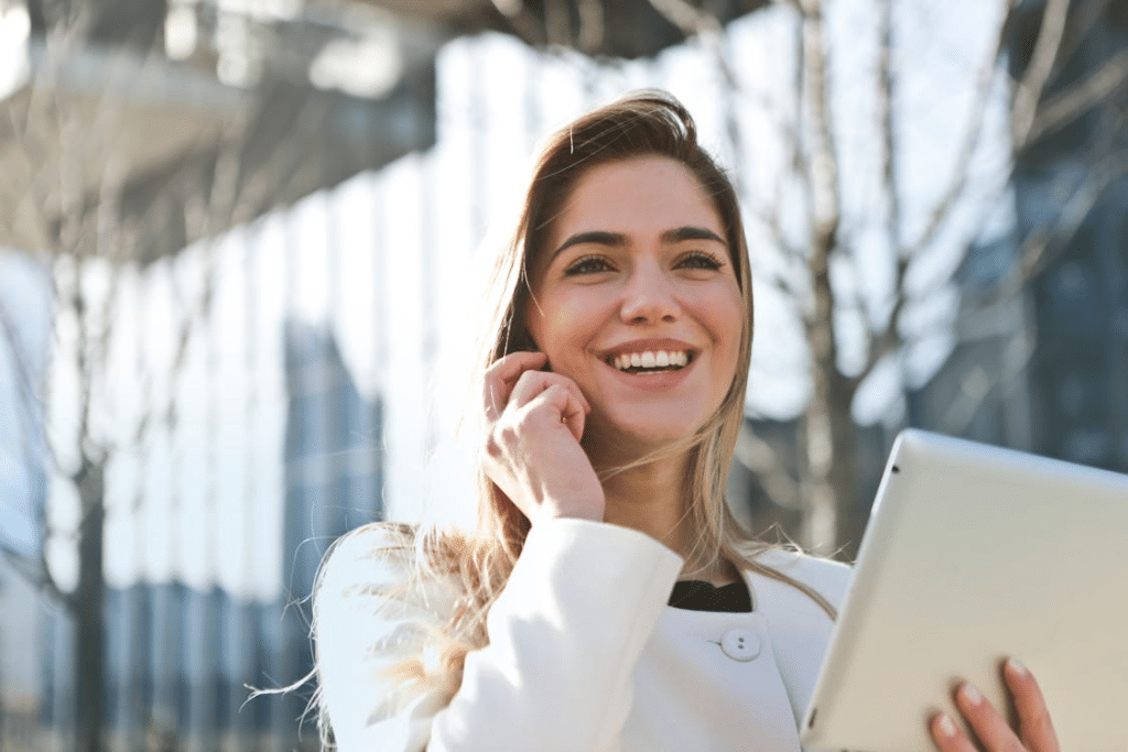 A woman smiling while talking to someone on the phone