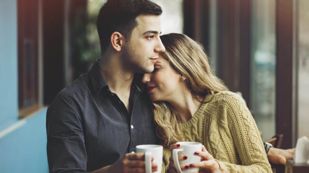 A couple in love drinking coffee and having fun in a coffee shop.