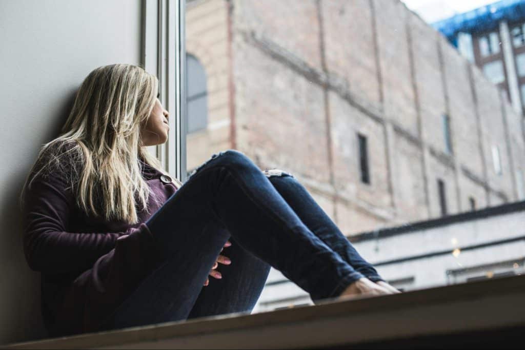 A woman looking at the window 