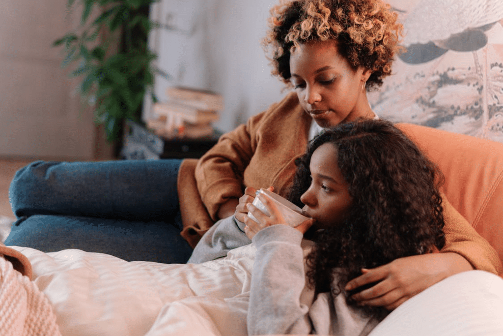 Mother and daughter sitting on a couch