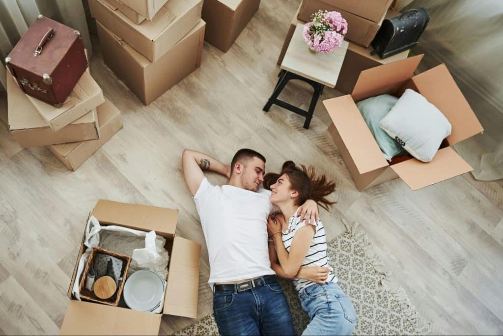 A man and woman talking while laying on the floor